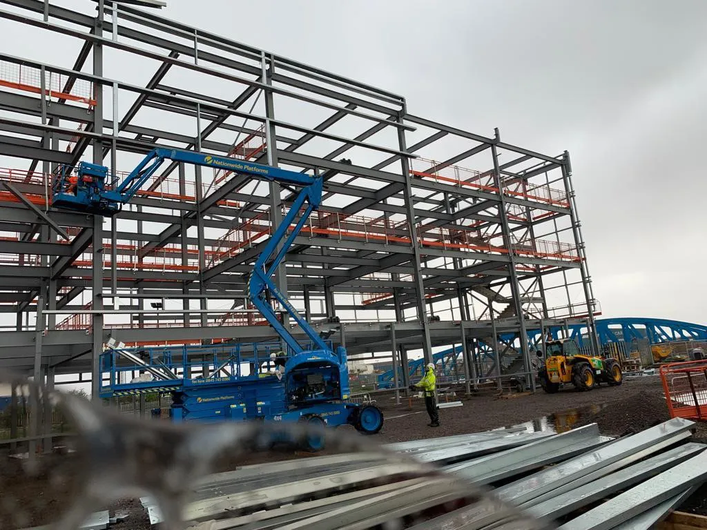 Cherry picker at work erecting a steel structure